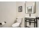 Modern powder room featuring a vessel sink, and an artistic painting at 2466 S Cherokee St, Denver, CO 80223