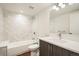 Modern bathroom featuring stylish tile work, a bathtub with shower, and a vanity with ample counter space at 2466 S Cherokee St, Denver, CO 80223