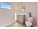 Bright bathroom featuring a toilet, sink, and cabinet at 2466 S Cherokee St, Denver, CO 80223
