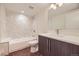 Modern bathroom featuring a tub, shower, and vanity with updated finishes and fixtures at 2466 S Cherokee St, Denver, CO 80223
