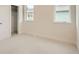 Neutral bedroom with a closet and natural light from two windows at 2466 S Cherokee St, Denver, CO 80223