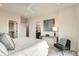 Bedroom featuring neutral decor, a patterned accent pillow, and ample lighting at 2466 S Cherokee St, Denver, CO 80223