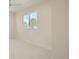 Bright bedroom with a large window, neutral color palette, and plush carpeting at 2466 S Cherokee St, Denver, CO 80223