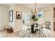 Bright dining area featuring a modern chandelier, glass table, and designer rug at 2466 S Cherokee St, Denver, CO 80223