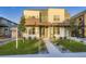 Modern two-story home with a well-manicured lawn and landscaped walkway leading to the front door at 2466 S Cherokee St, Denver, CO 80223