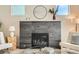 Close up on a modern gray tiled fireplace with a decoratively styled mantle in a sunlit room at 2466 S Cherokee St, Denver, CO 80223