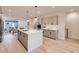 Open-concept kitchen featuring a large island with seating and modern stainless steel appliances at 2466 S Cherokee St, Denver, CO 80223