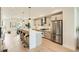 Spacious kitchen with stainless steel appliances, ample countertop space, and adjacent dining area at 2466 S Cherokee St, Denver, CO 80223