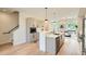 Open concept kitchen with modern appliances, quartz countertops, and adjacent dining room at 2466 S Cherokee St, Denver, CO 80223