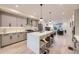 Spacious kitchen with gray cabinets, stainless steel appliances, an island with bar seating, and backyard access at 2466 S Cherokee St, Denver, CO 80223