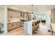 Modern kitchen with stainless steel appliances, counter seating, and open layout leading to the living area at 2466 S Cherokee St, Denver, CO 80223