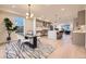 Bright, open concept kitchen with stainless steel appliances, a center island, and a seamless flow to the dining area at 2466 S Cherokee St, Denver, CO 80223