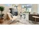 Bright living room boasts a modern fireplace, hardwood floors, and sliding glass doors to the backyard at 2466 S Cherokee St, Denver, CO 80223