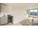 Bright living room with a wet bar, access to an outdoor deck, and mountain views at 2466 S Cherokee St, Denver, CO 80223