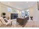 Bright living room with a fireplace, recessed lighting, and a sliding glass door to the backyard at 2466 S Cherokee St, Denver, CO 80223