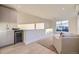A living room wet-bar and cabinets, with large windows in the back and a couch at 2466 S Cherokee St, Denver, CO 80223