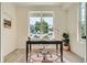 Home office bathed in natural light with desk, chair, and view of the outdoors at 2466 S Cherokee St, Denver, CO 80223