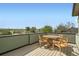 Outdoor rooftop deck with a table and chairs, offering a scenic view at 2466 S Cherokee St, Denver, CO 80223