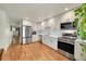 Spacious kitchen with stainless steel appliances, white cabinets, and subway tile backsplash at 6765 S Independence St, Littleton, CO 80128
