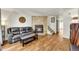 Inviting living room with stone fireplace, comfortable seating, and wood floors at 6765 S Independence St, Littleton, CO 80128