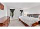 Comfortable main bedroom with neutral decor, two windows, and natural light at 6765 S Independence St, Littleton, CO 80128