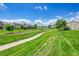 Scenic neighborhood park with a walking path surrounded by lush green grass at 6765 S Independence St, Littleton, CO 80128