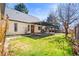 Spacious backyard with a deck, grass, and a charming back porch at 21 Snowmass Pl, Longmont, CO 80504