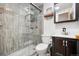 Modern bathroom featuring a glass-enclosed shower and vanity with dark wood cabinets at 21 Snowmass Pl, Longmont, CO 80504