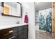 Bathroom with vanity, mirror, and shower featuring a decorative curtain at 21 Snowmass Pl, Longmont, CO 80504