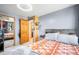 Bright bedroom featuring grey walls, a mirrored closet, and a doorway to the bathroom at 21 Snowmass Pl, Longmont, CO 80504
