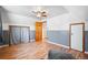 Bedroom with gray walls, wood laminate flooring, and ceiling fan at 21 Snowmass Pl, Longmont, CO 80504
