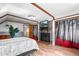 Bedroom with hardwood floors, fireplace and a TV at 21 Snowmass Pl, Longmont, CO 80504