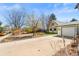 Inviting home featuring a detached garage, landscaped lawn, and paved driveway at 21 Snowmass Pl, Longmont, CO 80504