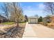 Lovely home showcasing a detached garage, well manicured lawn, and concrete driveway at 21 Snowmass Pl, Longmont, CO 80504