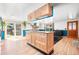 Bright kitchen with wooden cabinets, island, stainless appliances, and sliding door to backyard at 21 Snowmass Pl, Longmont, CO 80504