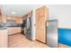 Bright kitchen features stainless steel appliances, wood cabinets and stylish backsplash at 21 Snowmass Pl, Longmont, CO 80504