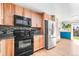Modern kitchen with stainless steel appliances, wood cabinets, and stylish backsplash at 21 Snowmass Pl, Longmont, CO 80504