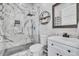 A renovated bathroom with marble tile, glass shower, and modern vanity at 499 Silver Creek Rd, Idaho Springs, CO 80452