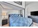 Well-lit bedroom with a lofted bunk bed and a large flatscreen TV atop a storage unit at 499 Silver Creek Rd, Idaho Springs, CO 80452