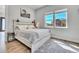 Bedroom featuring wood floors, natural light, a horse painting and neutral decor at 499 Silver Creek Rd, Idaho Springs, CO 80452