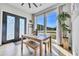 Bright dining area with a wooden table set, large windows, and an inviting view of the outdoors at 499 Silver Creek Rd, Idaho Springs, CO 80452