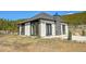 Charming home featuring a dark roof, stone facade, and modern black trim around windows at 499 Silver Creek Rd, Idaho Springs, CO 80452