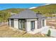 Modern home with gray roof and black framed windows against a mountain backdrop at 499 Silver Creek Rd, Idaho Springs, CO 80452