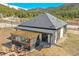 Modern home featuring a pergola-covered hot tub and fire pit area with mountain views at 499 Silver Creek Rd, Idaho Springs, CO 80452