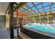 Hot tub on patio under wood pergola with privacy screen in wooded setting at 499 Silver Creek Rd, Idaho Springs, CO 80452