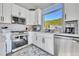 Beautiful kitchen features stainless steel appliances, white cabinets and gorgeous mountain views at 499 Silver Creek Rd, Idaho Springs, CO 80452