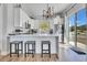 Modern kitchen with white cabinets, stainless steel appliances, and a spacious breakfast bar at 499 Silver Creek Rd, Idaho Springs, CO 80452