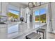 Bright kitchen with white cabinets, stainless appliances, quartz counters and mountain views at 499 Silver Creek Rd, Idaho Springs, CO 80452