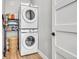 Practical laundry room featuring a stacked washer and dryer set with storage at 499 Silver Creek Rd, Idaho Springs, CO 80452