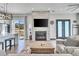 Stylish living room with a stone fireplace, modern furnishings, and a seamless flow into the kitchen at 499 Silver Creek Rd, Idaho Springs, CO 80452